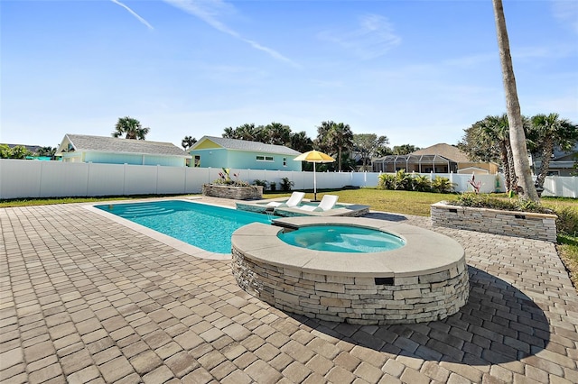 view of swimming pool featuring an in ground hot tub, a yard, and a patio area