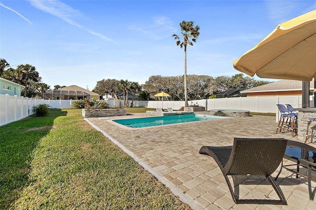 view of pool with a lawn and a patio area