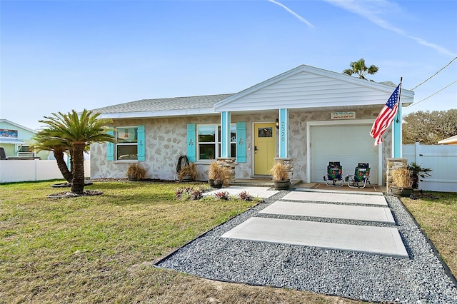 ranch-style home with a front lawn and a garage