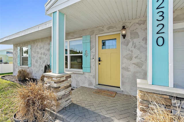 view of exterior entry with covered porch