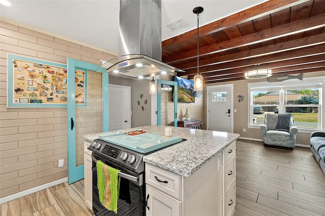 kitchen with white cabinetry, island exhaust hood, brick wall, and black / electric stove