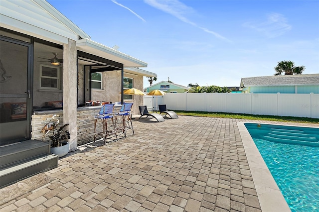 view of swimming pool with a patio area and exterior bar