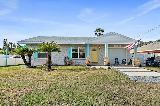 view of front of home with a garage and a front lawn