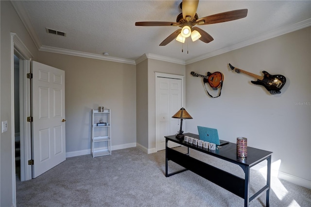 office space featuring a textured ceiling, ceiling fan, carpet floors, and ornamental molding