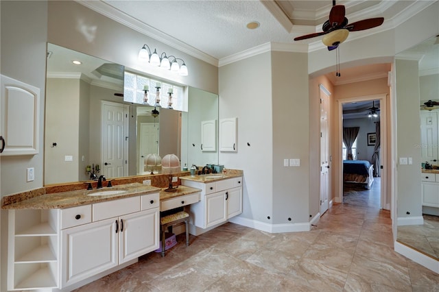 bathroom with ceiling fan, ornamental molding, and vanity