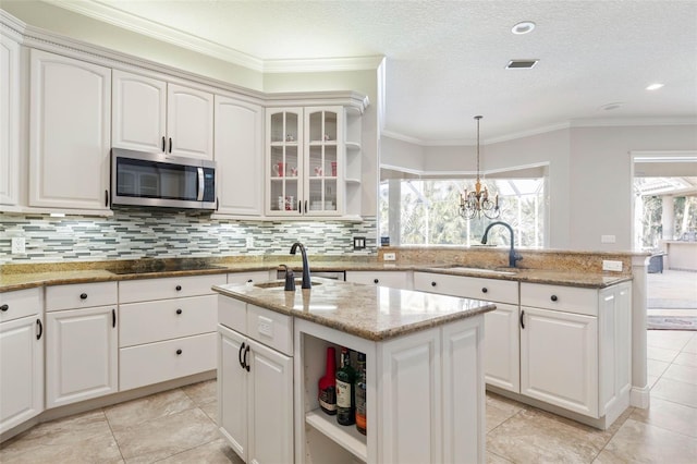 67 Island Estates Pkwy, Palm Coast, FL 32137 - kitchen featuring stainless steel microwave, open shelves, a sink, black electric cooktop, and ornamental molding