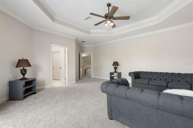 67 Island Estates Pkwy, Palm Coast, FL 32137 - living room with a tray ceiling, light carpet, ornamental molding, ceiling fan, and baseboards