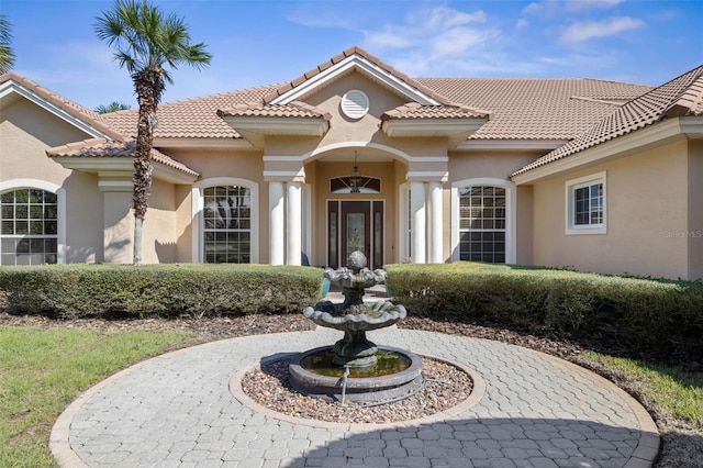 67 Island Estates Pkwy, Palm Coast, FL 32137 - doorway to property featuring stucco siding and a tiled roof