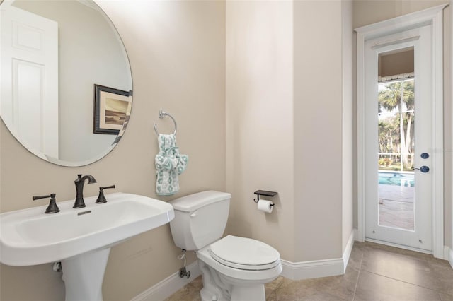 67 Island Estates Pkwy, Palm Coast, FL 32137 - half bathroom featuring baseboards, toilet, a sink, and tile patterned flooring