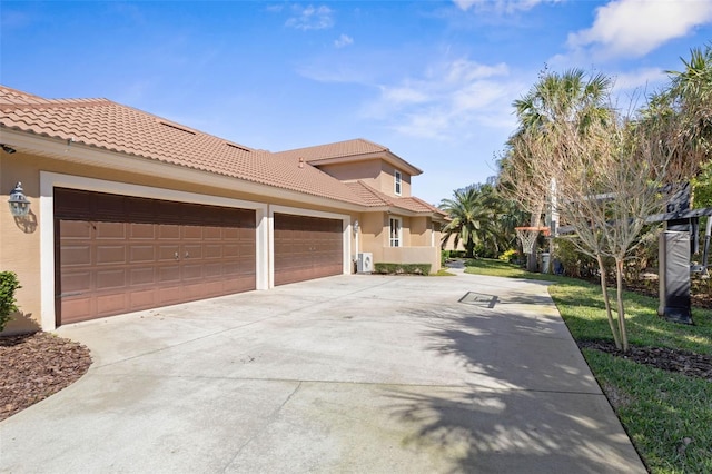 67 Island Estates Pkwy, Palm Coast, FL 32137 - view of property exterior with concrete driveway, stucco siding, a tile roof, and an attached garage