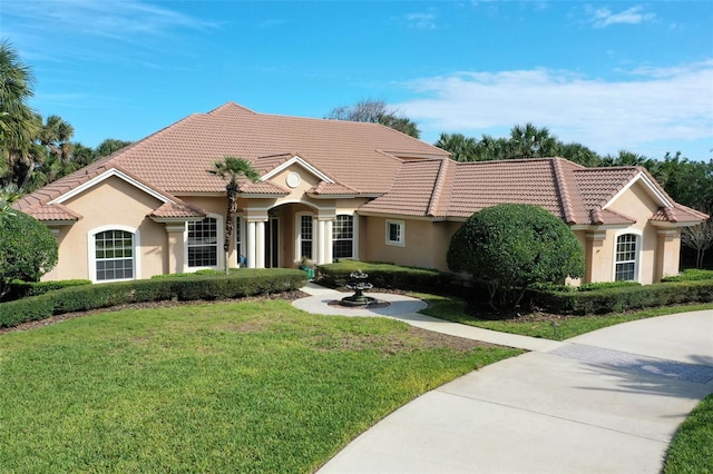 67 Island Estates Pkwy, Palm Coast, FL 32137 - mediterranean / spanish house featuring stucco siding, a front yard, and a tiled roof