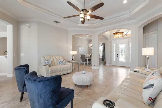 67 Island Estates Pkwy, Palm Coast, FL 32137 - living area with arched walkways, a tray ceiling, light tile patterned floors, crown molding, and ceiling fan