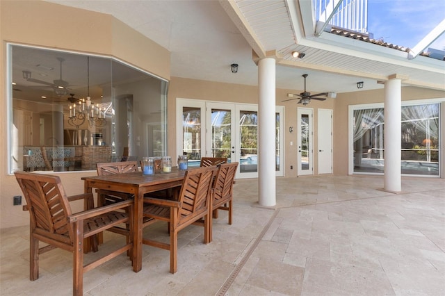67 Island Estates Pkwy, Palm Coast, FL 32137 - dining area with decorative columns, stone tile floors, french doors, a ceiling fan, and a chandelier