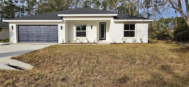 view of front facade with a garage, concrete driveway, roof with shingles, stucco siding, and a front yard