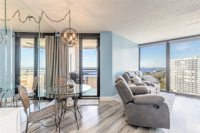 dining space with a wealth of natural light, expansive windows, and wood-type flooring