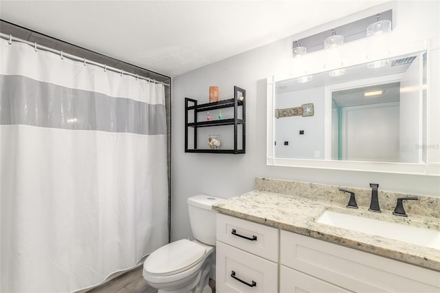 bathroom featuring a shower with shower curtain, vanity, hardwood / wood-style flooring, and toilet