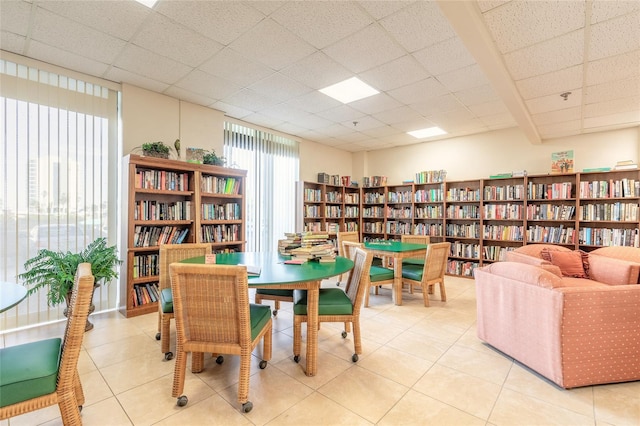 sitting room featuring light tile patterned floors and a paneled ceiling