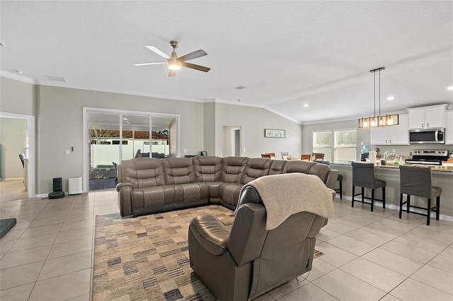 tiled living room with ornamental molding, ceiling fan, and lofted ceiling