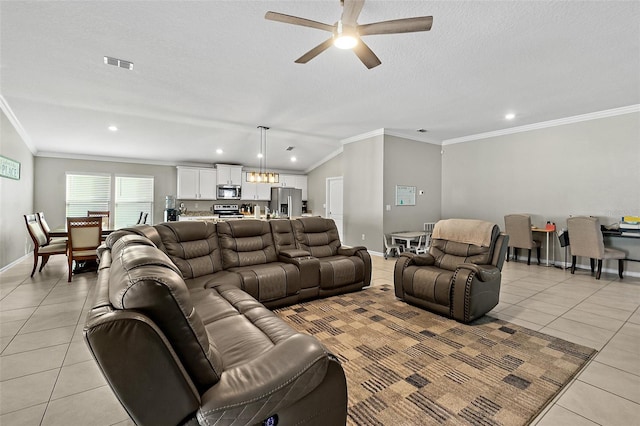 tiled living room featuring a textured ceiling, ceiling fan, and ornamental molding