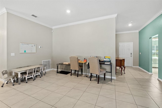 dining space featuring light tile patterned floors and crown molding