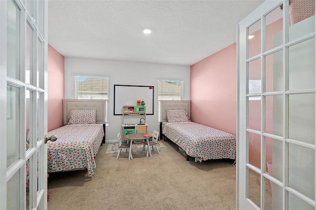 carpeted bedroom featuring a textured ceiling