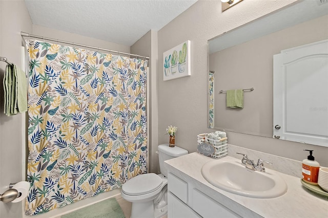 bathroom with vanity, a textured ceiling, and toilet