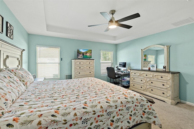 carpeted bedroom featuring ceiling fan and multiple windows