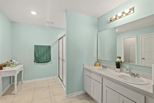 bathroom featuring tile patterned flooring, vanity, and walk in shower