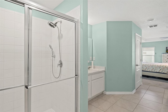 bathroom featuring tile patterned floors, vanity, and walk in shower