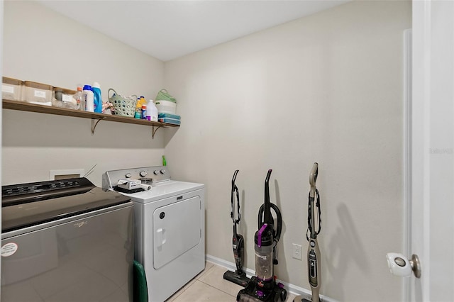 laundry area featuring washing machine and dryer and light tile patterned floors