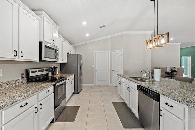 kitchen featuring white cabinets, crown molding, sink, vaulted ceiling, and appliances with stainless steel finishes