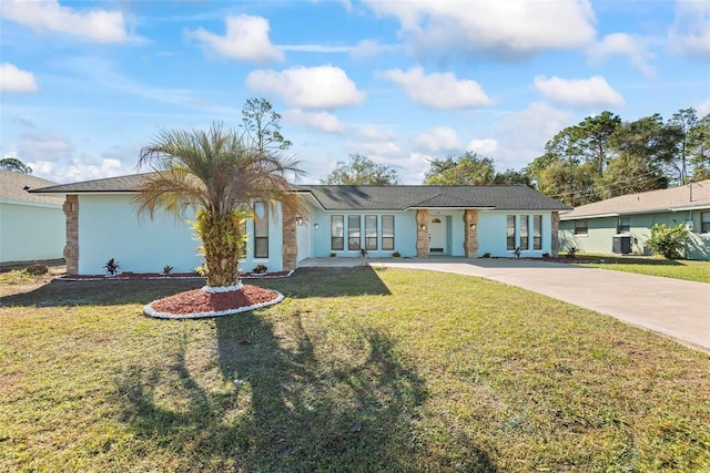 ranch-style house with a front yard and central air condition unit