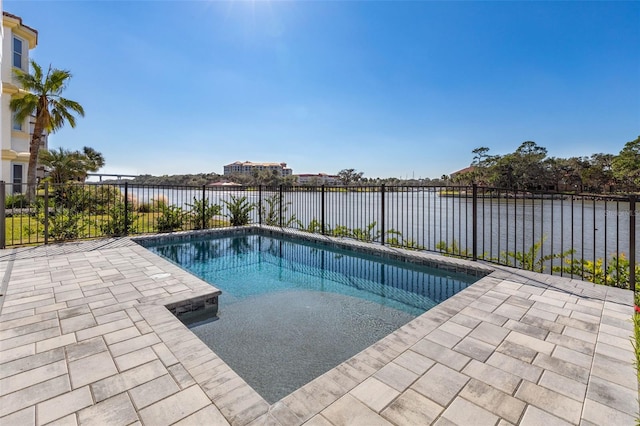 view of swimming pool featuring a patio and a water view