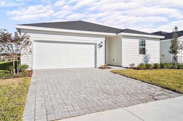 single story home featuring a front lawn and a garage