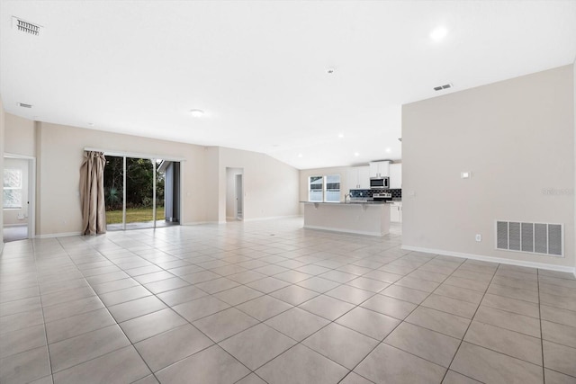 unfurnished living room with light tile patterned floors