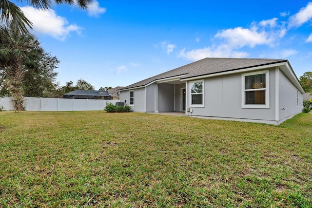 rear view of property featuring a yard