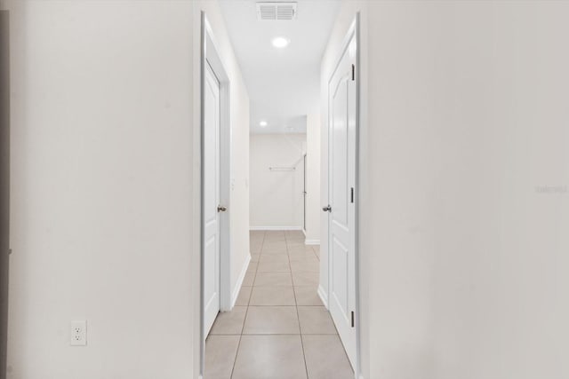 corridor featuring light tile patterned floors