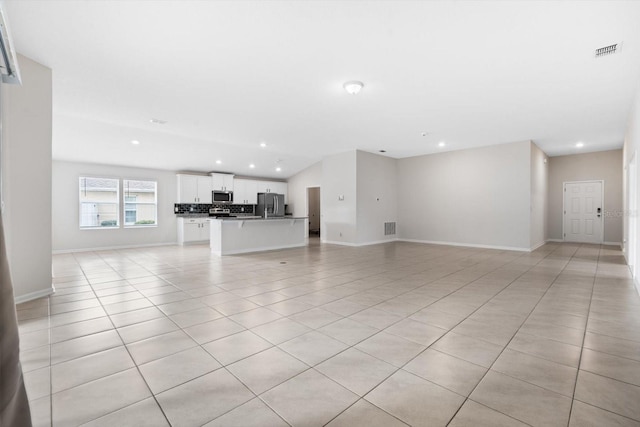 unfurnished living room with light tile patterned floors