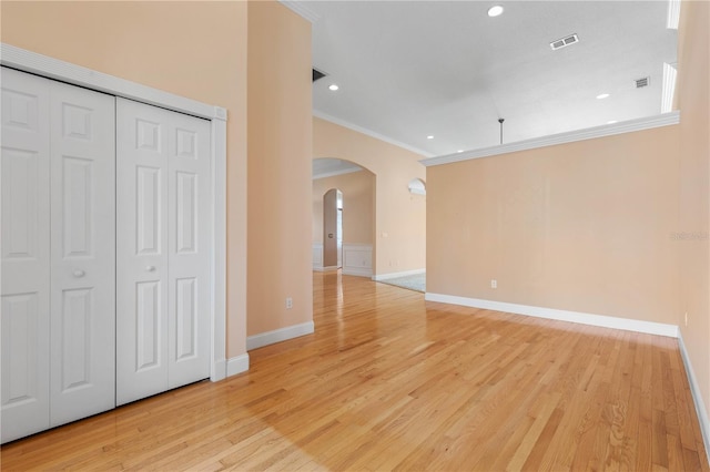 interior space with light hardwood / wood-style flooring and ornamental molding