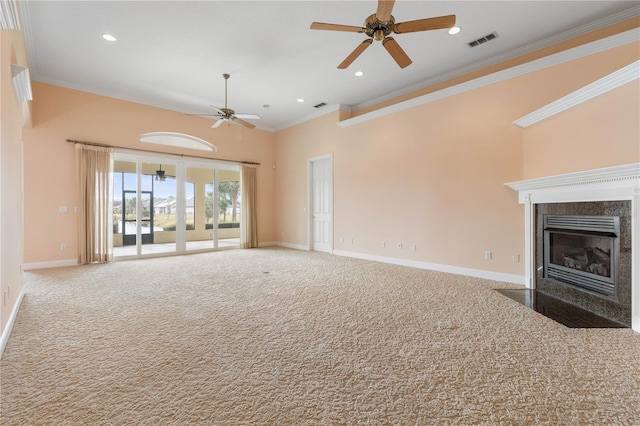 unfurnished living room featuring carpet, ceiling fan, crown molding, and a high end fireplace