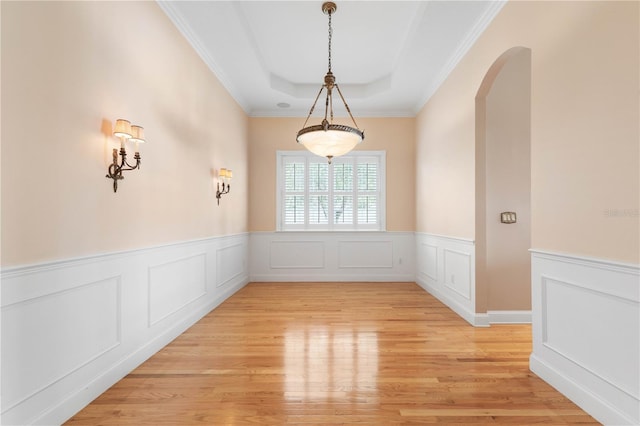 unfurnished dining area with crown molding and light hardwood / wood-style floors