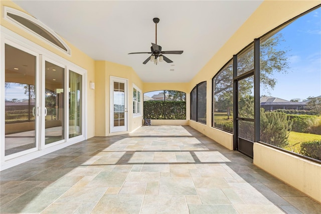 unfurnished sunroom with ceiling fan