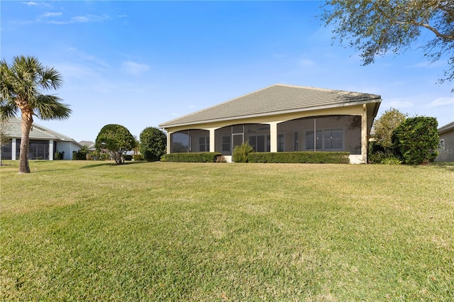 ranch-style home with a sunroom and a front yard