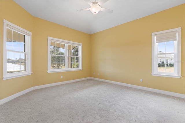 spare room featuring ceiling fan and light colored carpet