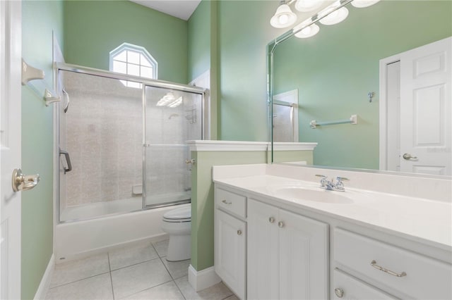 full bathroom featuring tile patterned floors, vanity, toilet, and bath / shower combo with glass door