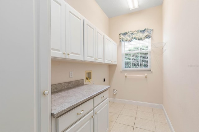 washroom featuring hookup for an electric dryer, hookup for a washing machine, cabinets, and light tile patterned flooring