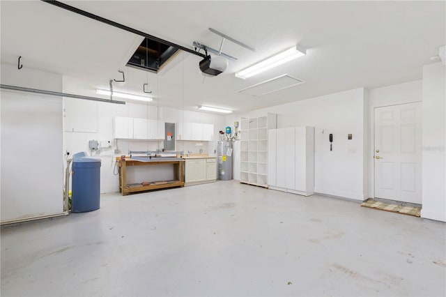 garage with sink, a workshop area, water heater, electric panel, and a garage door opener