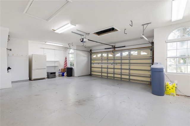 88 Longview Way N, Palm Coast, FL 32137 - garage featuring freestanding refrigerator and a garage door opener