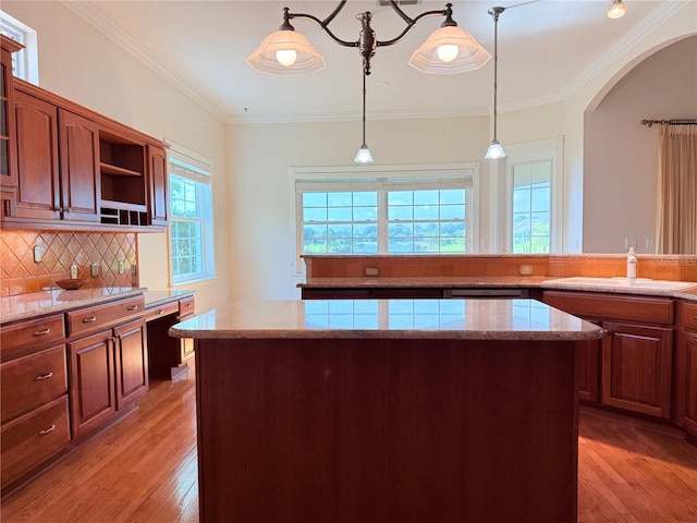 88 Longview Way N, Palm Coast, FL 32137 - kitchen with light wood-style floors, open shelves, backsplash, a kitchen island, and pendant lighting