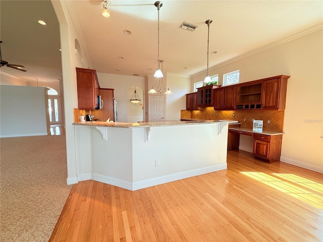 88 Longview Way N, Palm Coast, FL 32137 - kitchen featuring a breakfast bar, open shelves, backsplash, crown molding, and a peninsula